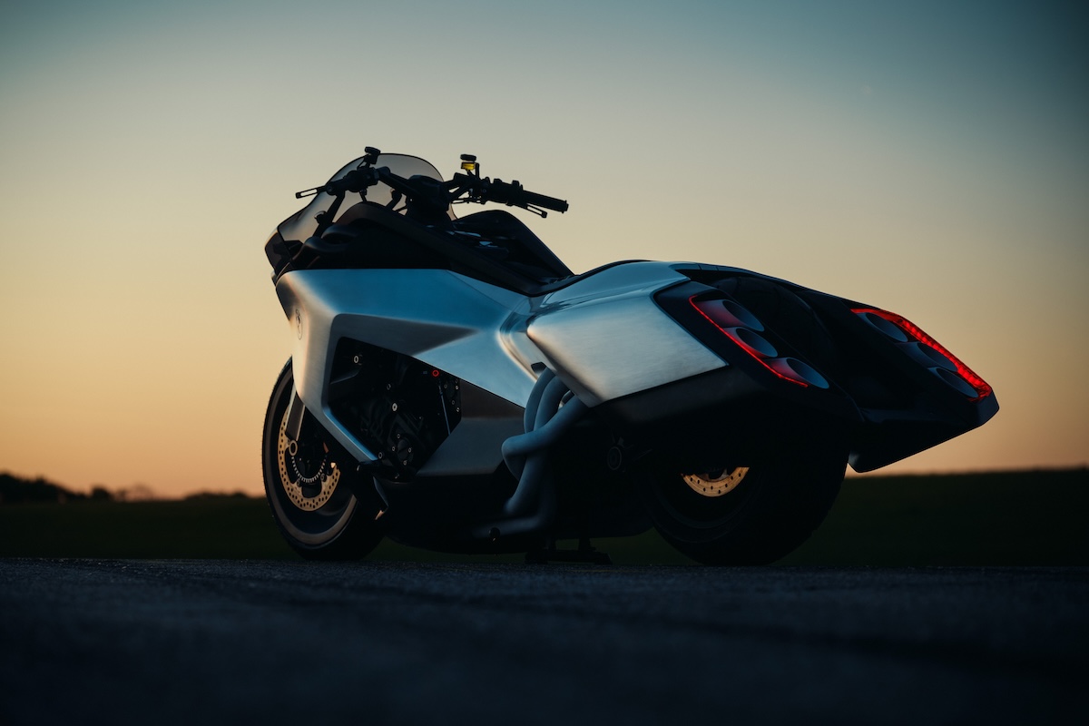 BMW Motorrad Vision K18 rear three-quarter at sunset showing six exhaust headers and tail lights