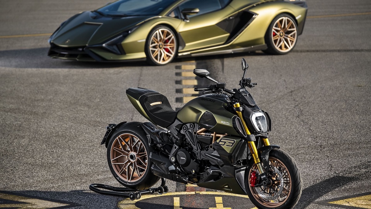 Diavel 1260 Lamborghini motorcycle in front of a Sian FKP 37 Verde Gea showing the 63 emblem on the tank
