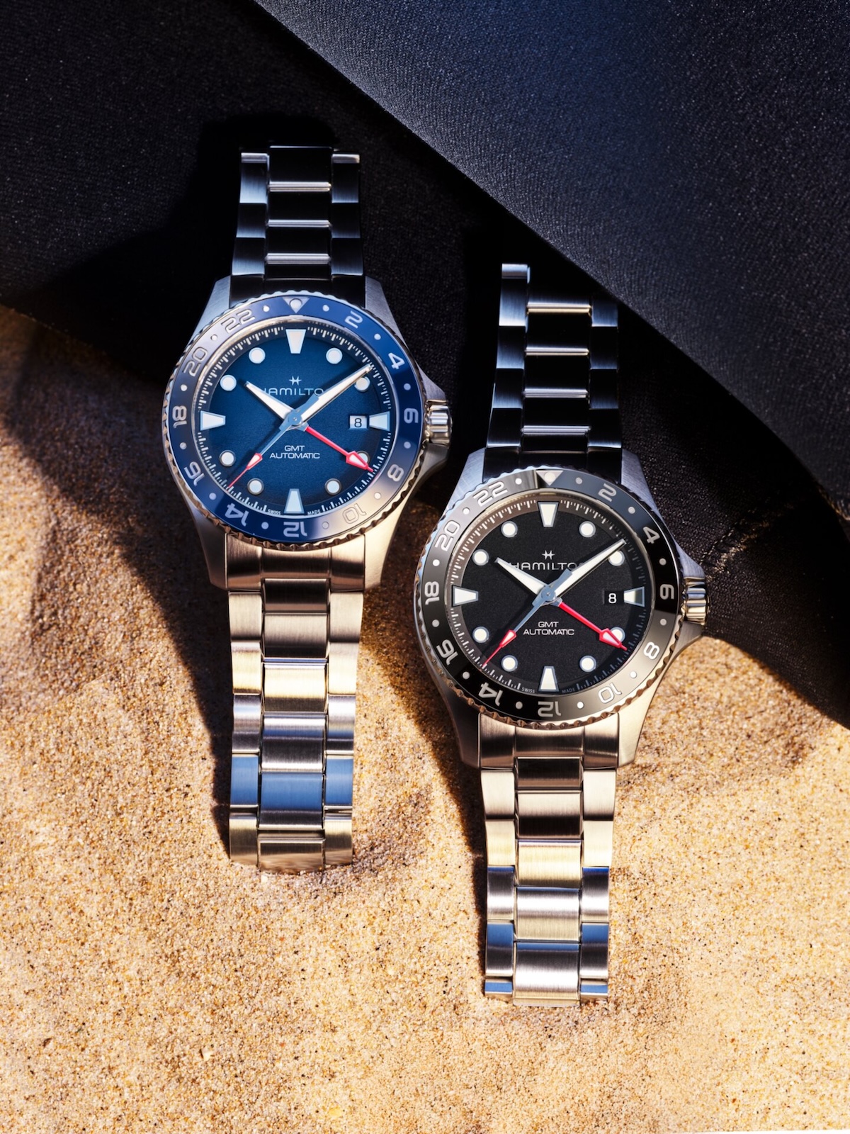 Hamilton Khaki Navy Scuba Auto GMT 43mm in blue gradient and black dial on steel bracelets, laid on sand
